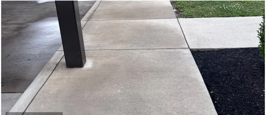 Concrete walkway beside carport