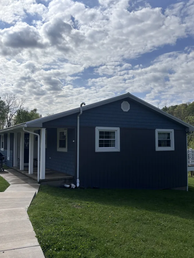 Dark siding two-story home after wash