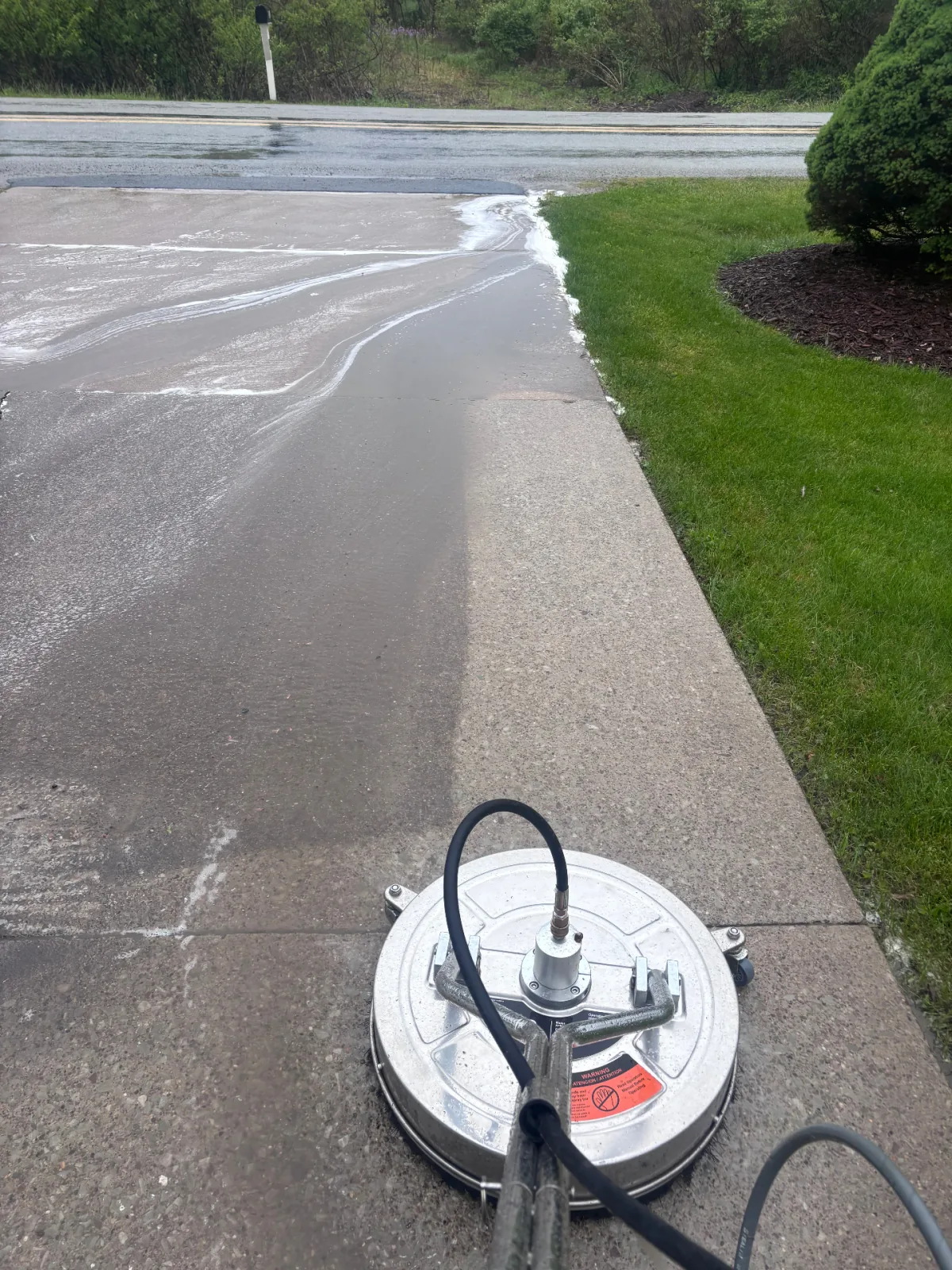 Driveway being cleaned with a surface cleaner
