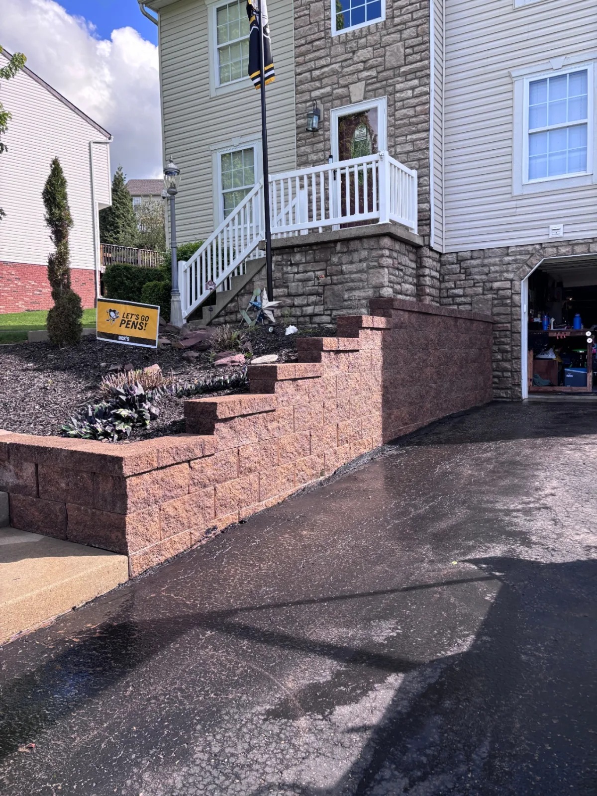 Retaining wall and driveway after cleaning